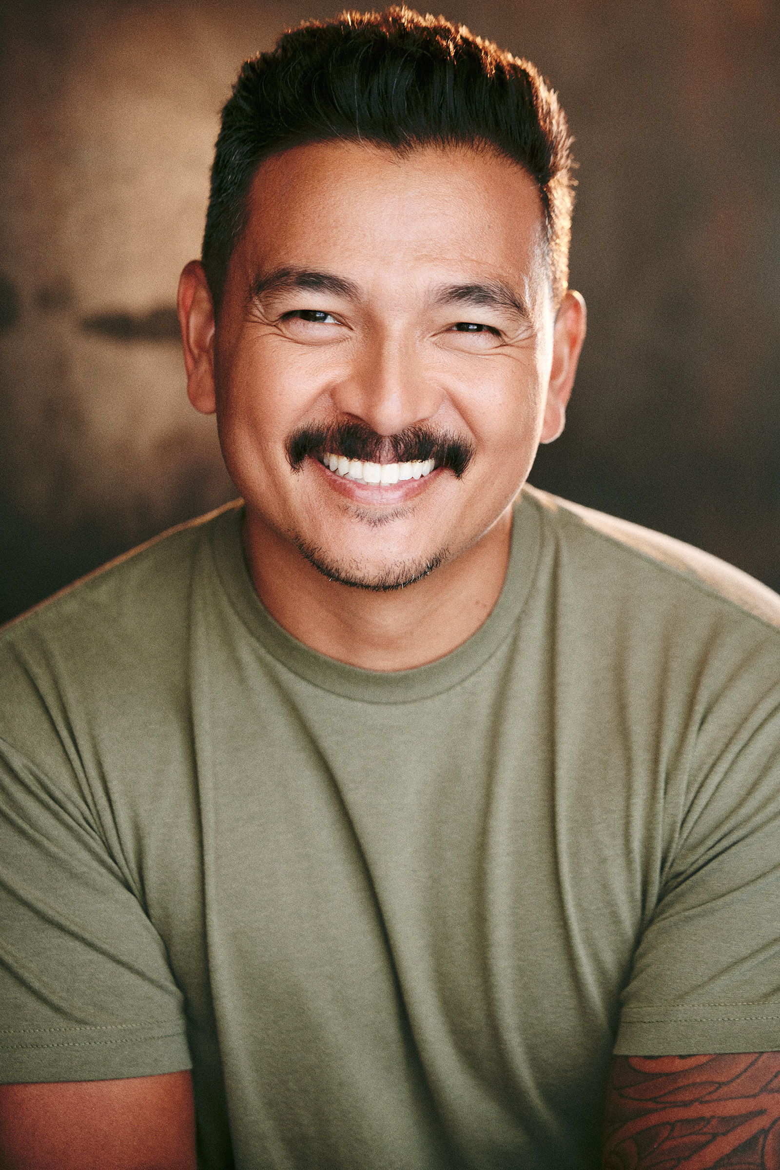 headshot smile showing teeth and mustache